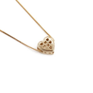 Gold plated heart pendant necklace with geometric cutout patterns on white background