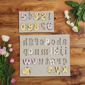 Alphabet and number silicone molds for DIY cake fondant and clay on wooden background
