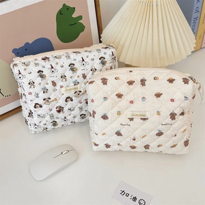 Detail of quilted floral dog and bear patterns on large capacity cotton makeup bags