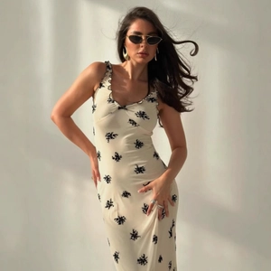 Close-up of V-neck floral print maxi dress with lace straps and slim fit design
