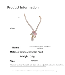 Detail view of pink ceramic flower and teardrop pearl necklace with sizing specifications