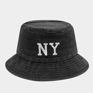 Close-up of white NY embroidery on dark gray washed cotton bucket hat with clean stitching