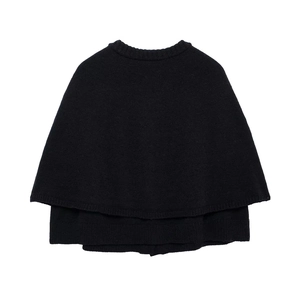 Detail shot of black layered knitted shawl with elegant round neck and button closure