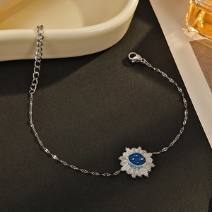 Silver celestial sun bracelet with blue enamel, star patterns and light blue rhinestones