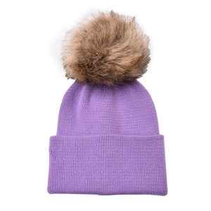 Close-up of purple knit winter hat with a fluffy brown pom-pom and ribbed texture