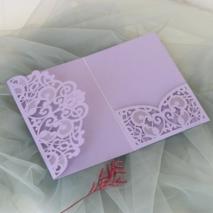 Detailed laser-cut purple lace invitation with elegant floral hollow patterns
