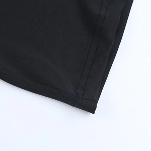 Detailed close-up showing precision double-needle stitching on black knitted fabric