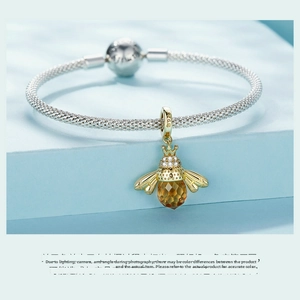 Detail of S925 sterling silver mesh bracelet and amber crystal bee pendant with zircon