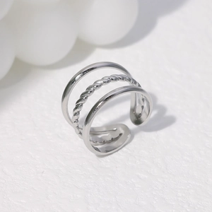 Macro shot of silver triple-layered open ring with twist texture and smooth bands