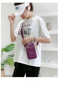 Detail of purple nylon cross-body phone bag with golden Logo and dual zipper pockets
