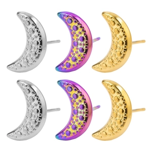 Detailed macro view of moon-shaped earrings in gold silver and purple iridescent finishes
