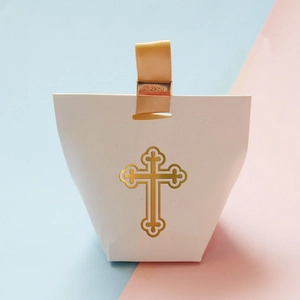 White trapezoid gift box with gold cross and ribbon for wedding or christening