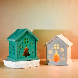 Wooden Christmas candle holders with hollow snowflake and tree patterns in blue and white