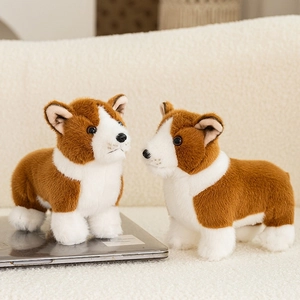 Cute realistic Corgi stuffed animal plush toy standing on a laptop for display