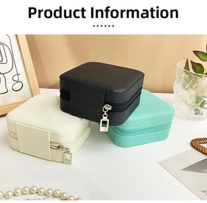 Detailed view of portable square PU leather jewelry boxes in black, white, and mint green