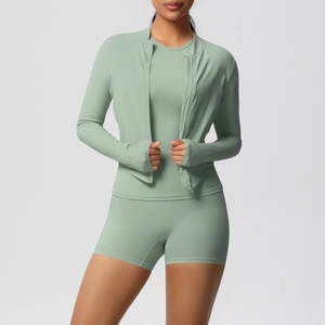 Detail of sage green yoga set showing zip jacket with thumbholes and high waist shorts