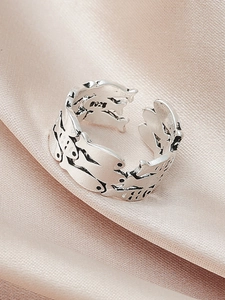 Detailed close-up of S925 sterling silver open ring with embossed swimming fish pattern