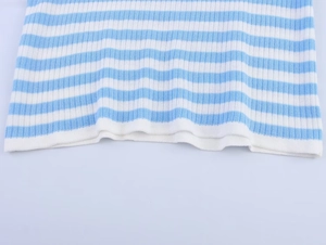 Close-up of blue and white striped knit texture and hem detail on women's sweater