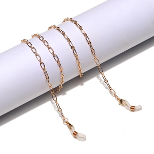 Detailed shot of golden metal glasses chain with lobster clasps and silicone loops