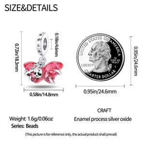 Macro detail of red enamel butterfly bead with skull design and 1.6g weight scale