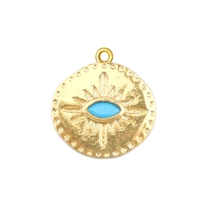 Macro shot of gold-plated Evil Eye pendant with blue turquoise and radial texture