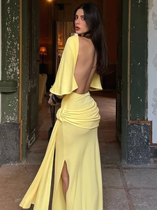 Elegant yellow backless maxi dress with long sleeves and pleated slit detail