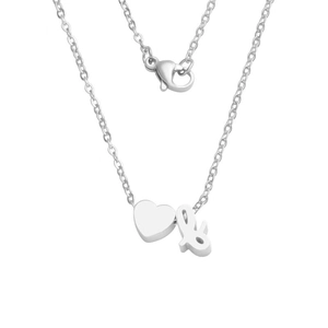Detailed macro view of polished stainless steel heart and ampersand necklace pendants