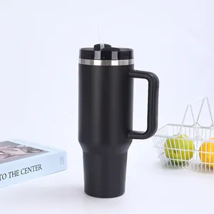 Close-up of 40oz matte black insulated tumbler with D-handle and straw in car cup holder