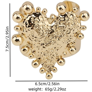 Vintage gold wide cuff bracelet featuring a large heart with hammered metal texture