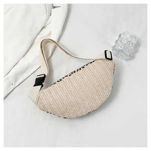 Detail of beige straw fanny pack featuring herringbone weave and black buckle closure