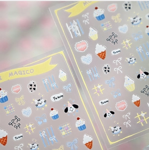 Detail of cute cartoon dog and cupcake nail stickers with pastel macaron tones