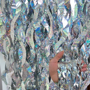 Macro shot of silver holographic foil curtain with shimmering rainbow effect for parties