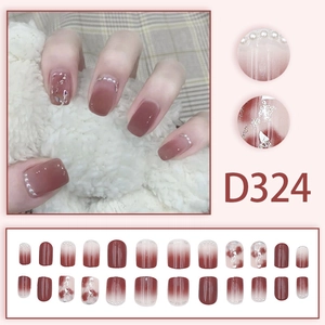 Short square press-on nails with red-brown gradient, pearls, and silver glitter accents