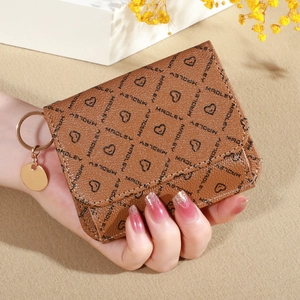 Close-up of brown litchi grain wallet with Madley monogram print and metal keychain