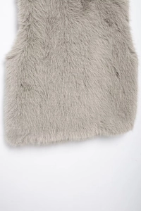 Detailed macro view of plush faux fur texture on the sleeveless grey autumn vest