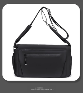 Detail showing the adjustable wide shoulder strap and waterproof nylon texture of the bag