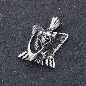 Detail of silver grim reaper skull pendant with wings and scythe in gothic style