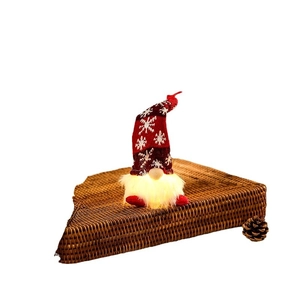 Lighted Christmas gnome plush with red snowflake hat and warm glowing beard on wicker base