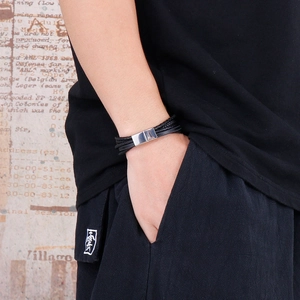 Men's multi-layer braided leather bracelet with silver magnetic clasp in lifestyle setting