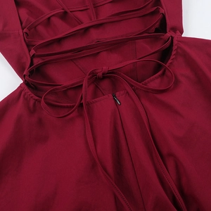 Detail of burgundy dress back with lace-up cross ties and a hidden zipper closure