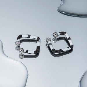 Minimalist square zebra pattern earrings with silver spheres and mirror water reflections