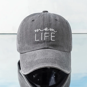 Close-up of mom LIFE embroidery on charcoal washed cotton baseball cap with vintage texture
