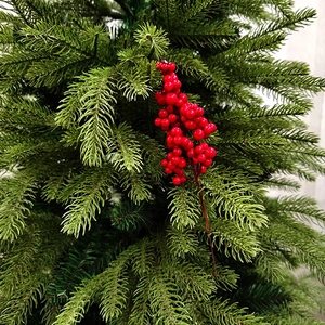 Close-up of bright red artificial holly berries on stems for holiday home decoration