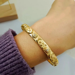 18K gold plated stainless steel bangle with engraved star and moon celestial motifs