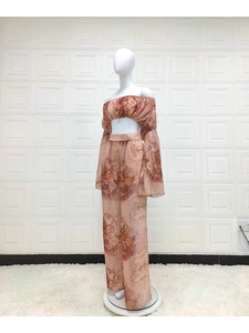 Floral chiffon off-shoulder long sleeve top and wide leg pants set on a mannequin