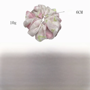 Detail view of floral polyester hair scrunchie with 14cm diameter and 6cm width dimensions