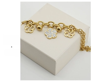 Detailed view of 18K gold rose flower bracelet with sparkling crystals on gift box