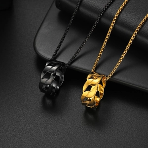 Minimalist gold and black chain ring necklaces set on a sleek dark background