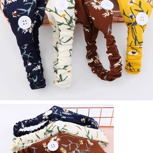 Detail view of daisy print chiffon headbands with functional buttons in four colors