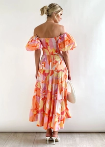 Rear view of vibrant abstract print maxi dress with bubble sleeves and high waist design
